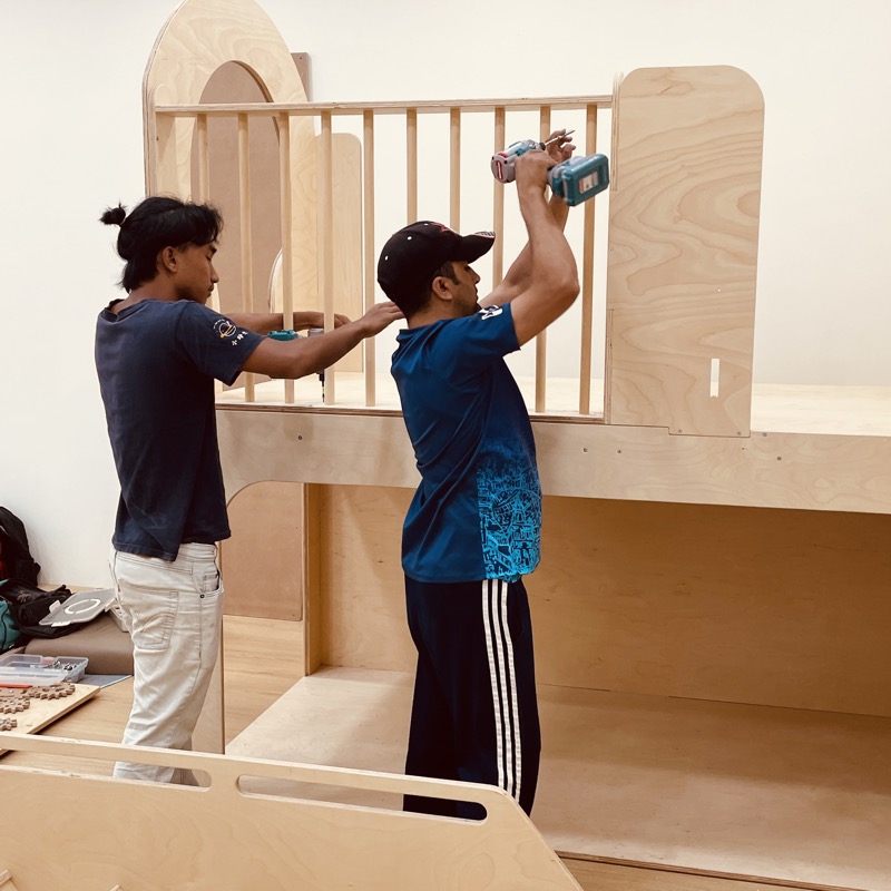 Team installing wooden playground on site